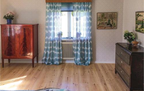 a living room with a dresser and a window at Holiday Home Lilla Öboängen Lidköping in Sjövik