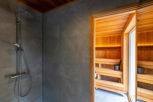 a bathroom with a shower and a shower stall at Jõeranna Pond House in Jõeranna