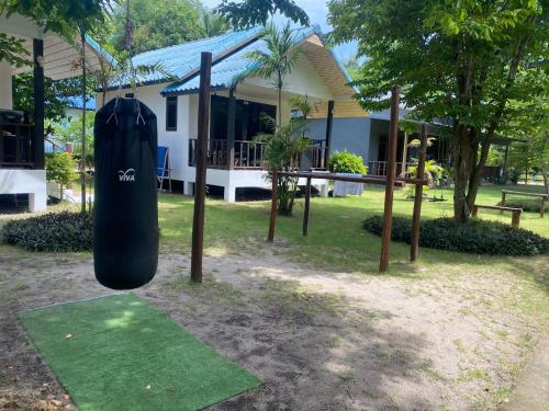 a surfboard on display in front of a house at Tiki Beach Koh Phangan Beach Restaurant Bar and Coworking in Ban Tai