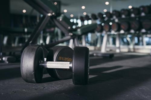 a pair of dumbbells on the floor of a gym at Opero Hotel Southkey Johor Bahru in Johor Bahru