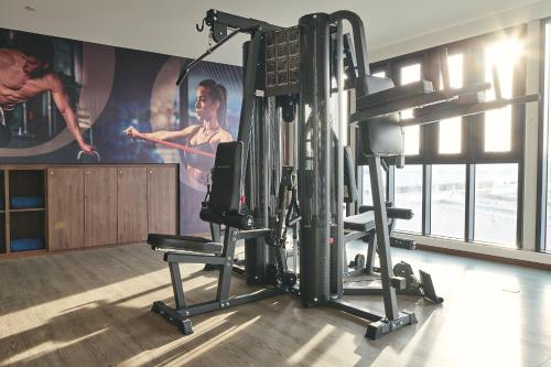 a room with a gym with a woman on a wall at Opero Hotel Southkey Johor Bahru in Johor Bahru