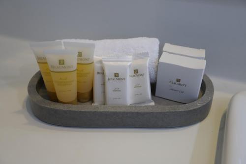 a shelf with four moisturizers and other products on it at Reign Inn Newcastle in Newcastle