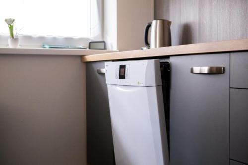 a small refrigerator under a counter in a kitchen at Chaty Ferrata in Martin