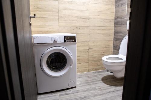 a bathroom with a washing machine and a toilet at Chaty Ferrata in Martin
