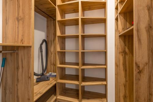 a closet with wooden shelves in a room at Простора квартира Віп на вулиці Під Голоском 15 Б in Lviv