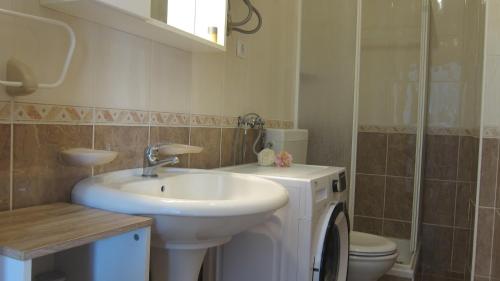 a bathroom with a sink and a toilet at Apartment Marina in Srima