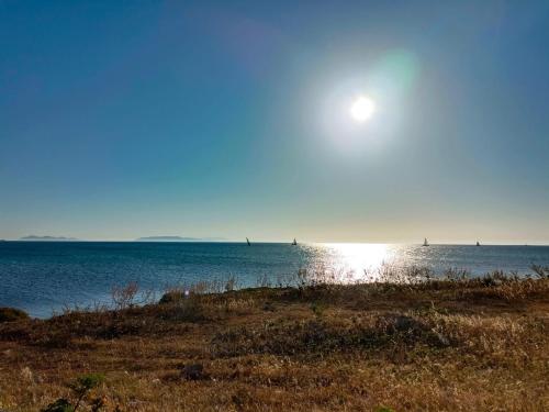 a sun setting over the ocean with sailboats in the water at GIOIA'S HOUSE in Custonaci