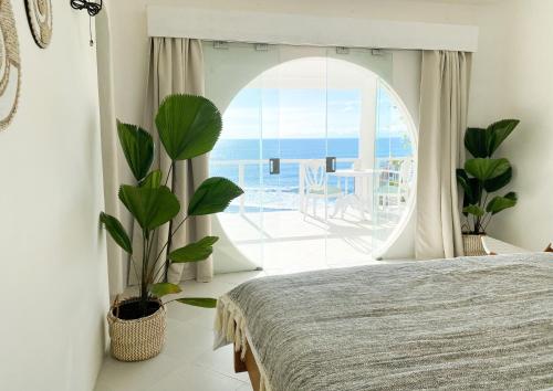 a bedroom with a bed and a view of the ocean at Blue Ocean Bingin in Uluwatu