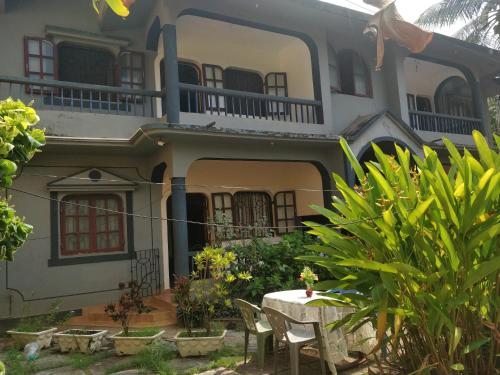 a house with a table in front of it at Koito-House calangute guest house in Calangute