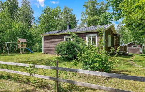 a small house with a playground in the yard at 2 Bedroom Beautiful Home In Källby in Mellby