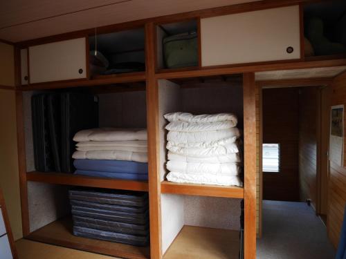 a group of towels in a cabinet with towels at Guest House Inujima / Vacation STAY 3516 in Toyama