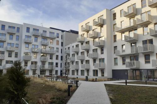 an apartment building with balconies and a walkway at Komfortowy apartament z balkonem i parkingiem in Wrocław