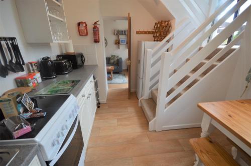 a kitchen with a stove and a counter top at Villa 23 in Wootton Bridge