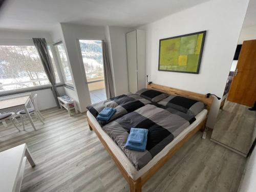 a bedroom with a large bed with blue bags on it at Appartement Ferienregion Bad Gastein in Bad Gastein