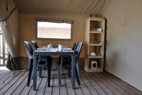 a blue dining table with chairs in a tent at Minicamping de Vrolijke Flierefluiter in Someren-Heide