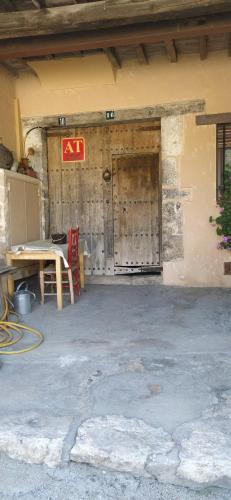 a building with a wooden door with a sign on it at El Pretil del Olmo in Cuenca