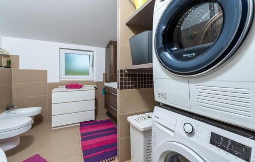 a bathroom with a washer and a washing machine at Apartman David with Balcony in Dračevac