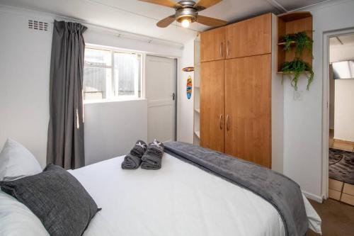 a bedroom with a bed with two shoes on it at HQ Warm and Cosy 1 Bedroom Unit In Sea Point in Cape Town