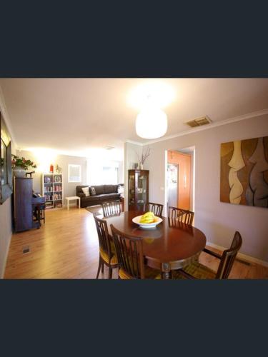a dining room and living room with a table and chairs at ravenhill house in Eumemmerring