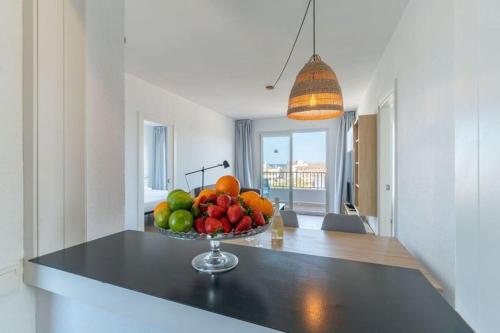 a bowl of fruit on a counter in a kitchen at Apartaments La Perla Negra in Cala Ratjada