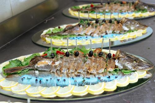 three plates of fish sitting on a table at Medeu in Kostanay