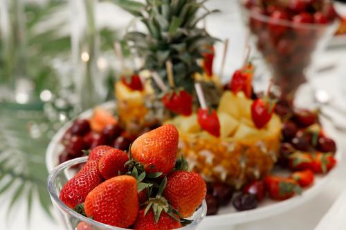 a bowl of strawberries and other fruit on a plate at Medeu in Kostanay