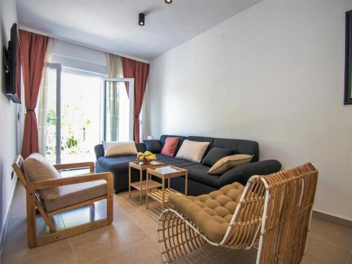 a living room with a couch and a table at Apartmani Melita in Malinska