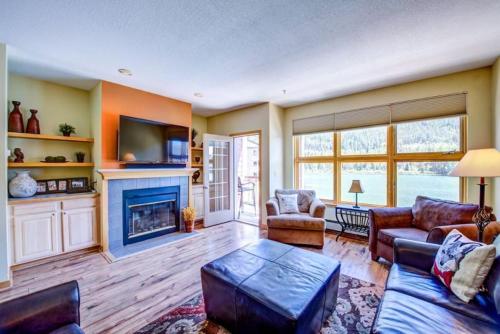 a living room with a couch and a fireplace at 100-2 Lakeside Village in Keystone