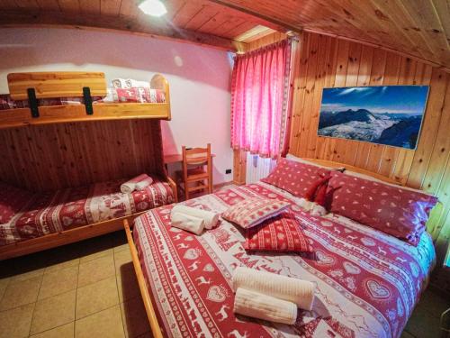 a bedroom with a bed in a room with mountains at La Piana Appartamenti in Alpe Devero
