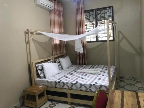 a bedroom with a bunk bed with a canopy at L&J Modern Backpackers Kinondoni in Dar es Salaam