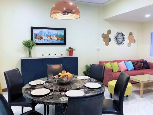 a living room with a table and a couch at At FOUR-6 Bed, CITY CENTER, Nana BTS, MBK, Central World, Siam in Bangkok