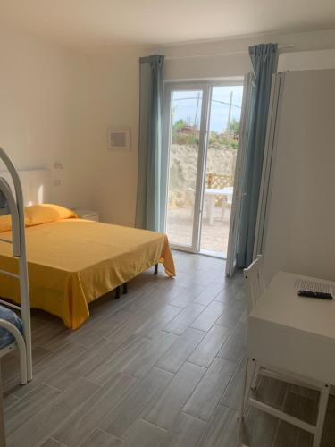 Schlafzimmer mit einem Bett und einer Glasschiebetür in der Unterkunft Residence Andrea a mare in Ischia