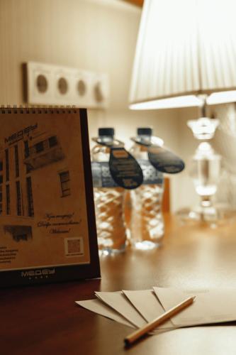 a table with a book and chopsticks on a table at Medeu in Kostanay