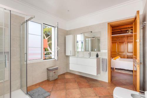 a bathroom with a shower and a sink and a mirror at Villa Maria Isabel in Cala Blanca