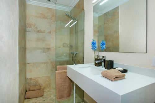 a bathroom with a white sink and a shower at Villa Casa Pepe by Villa Plus in Pollença