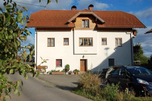 a large white house with a brown roof at Mentebauer Traudi's Ferienhof in Rothenthurn