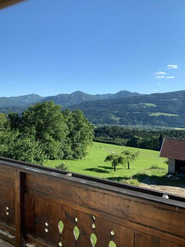 a view from the balcony of a house with a green field at Mentebauer Traudi's Ferienhof in Rothenthurn