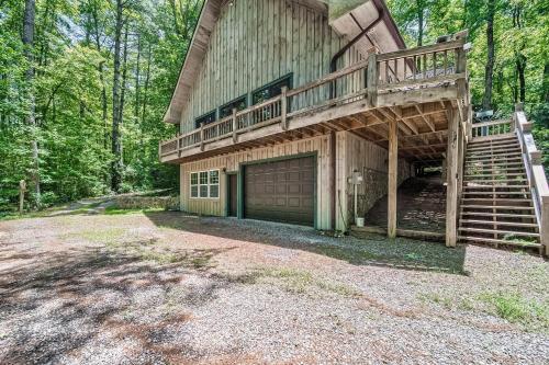 a large house with a deck and a garage at Osprey Landing in Clarkesville