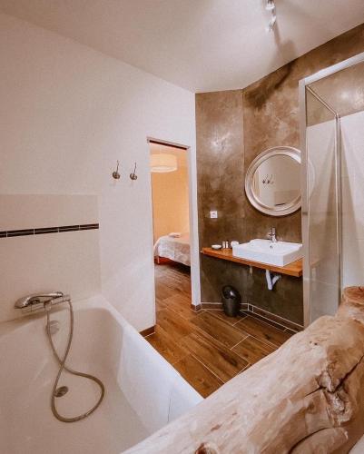 a bathroom with a bath tub and a sink at Auberge De La Foret Bonifatu in Calenzana