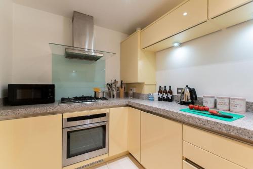 a kitchen with a stove and a counter top at Wingtips in Carbis Bay