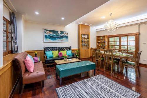 a living room with a couch and a table at AT NANA-5Bed, CITY CENTER, Nana BTS, MBK, Central World, Siam in Bangkok
