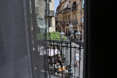 a view of a city street from a window at Suite Garibaldi in Cefalù