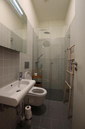 a bathroom with a toilet and a sink and a shower at OPORTO GUEST Natária Flats with Parking in Porto