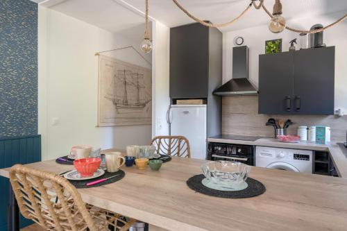 - une cuisine avec une table en bois dans l'établissement Rez-de-jardin pour 3 personnes proche de la plage, à Pornic