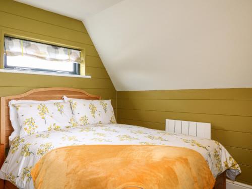 a bedroom with a bed with green walls at Buttercup Lodge in Doncaster