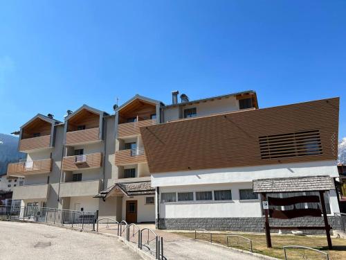 a large apartment building with a brown roof at Àlia Bianca Active & Family Hotel in Andalo