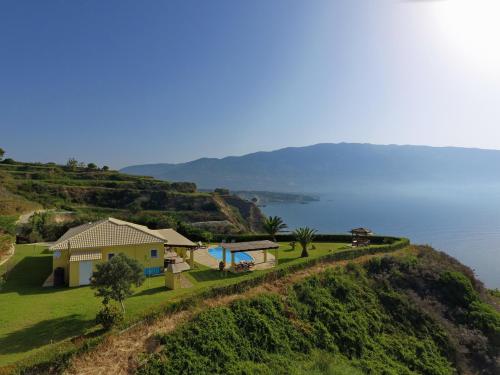 a house on a hill with a view of the water at Villa Hephaestus Spartia Kefalonia in Spartia