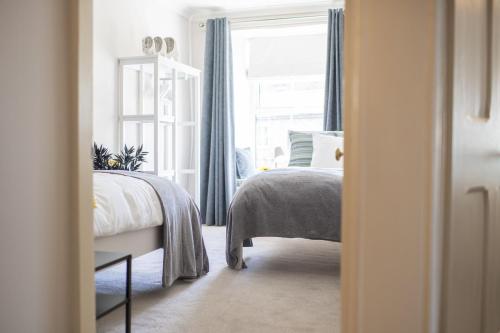 a bedroom with a bed and a window at Brook House in Askrigg