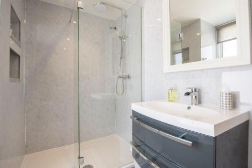 a bathroom with a sink and a shower at Brook House in Askrigg