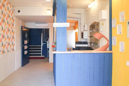 a kitchen with a blue counter in a room at Mon P'tit Hôtel in Le Grau-dʼAgde